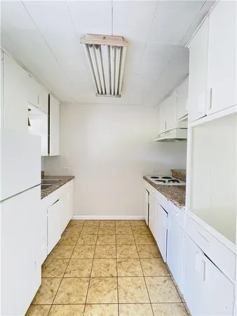 a large kitchen with granite countertop a stove a sink dishwasher and a refrigerator