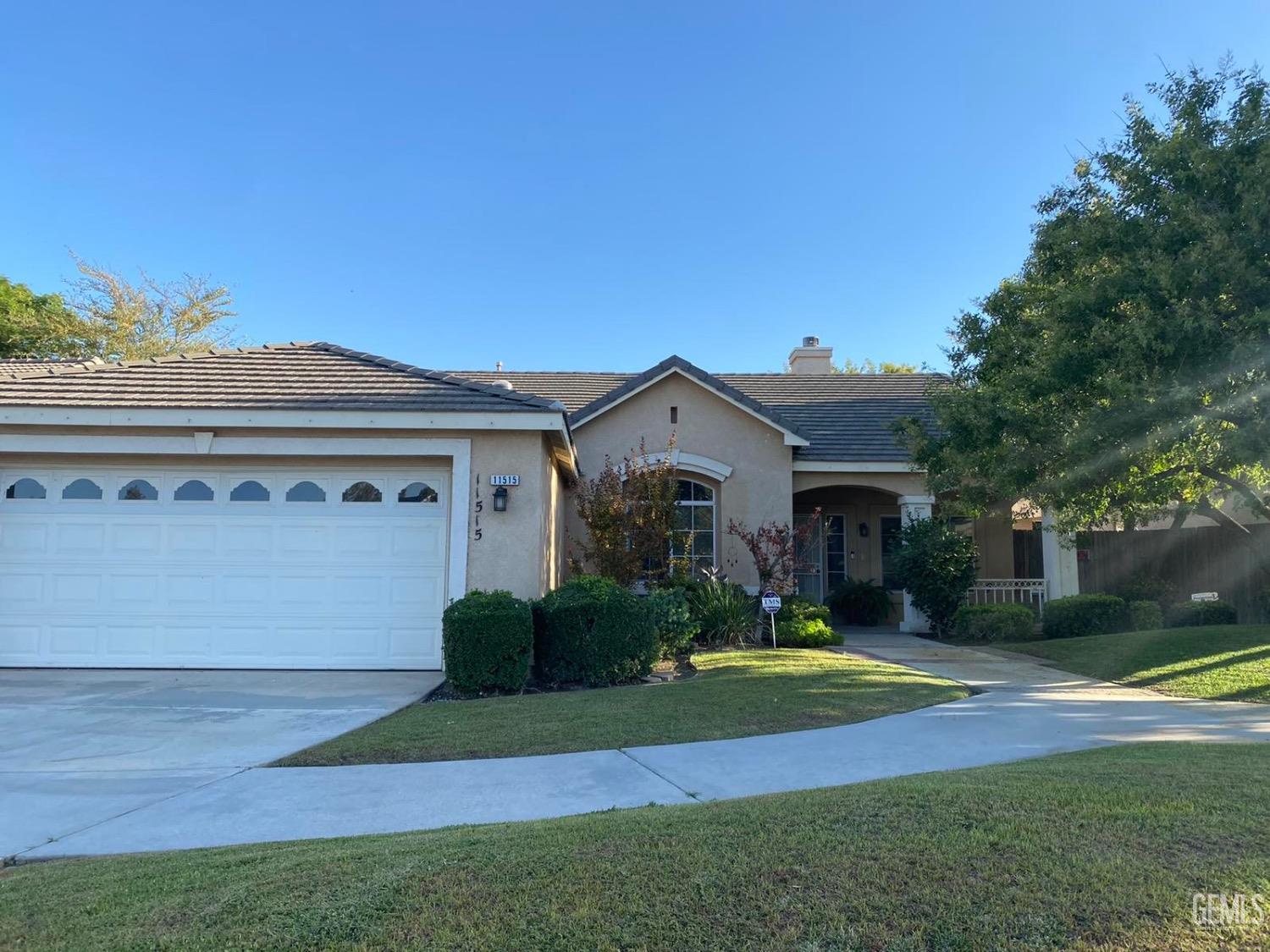 Undisclosed Address Bakersfield, CA 93311 - Photo 2 of 4 a front view of a house with a yard and garage