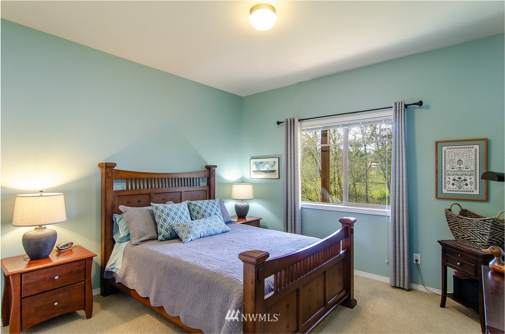 15 South Bank Road Elma, WA 98541 - Photo 15 of 32 a bed room with a bed and a window