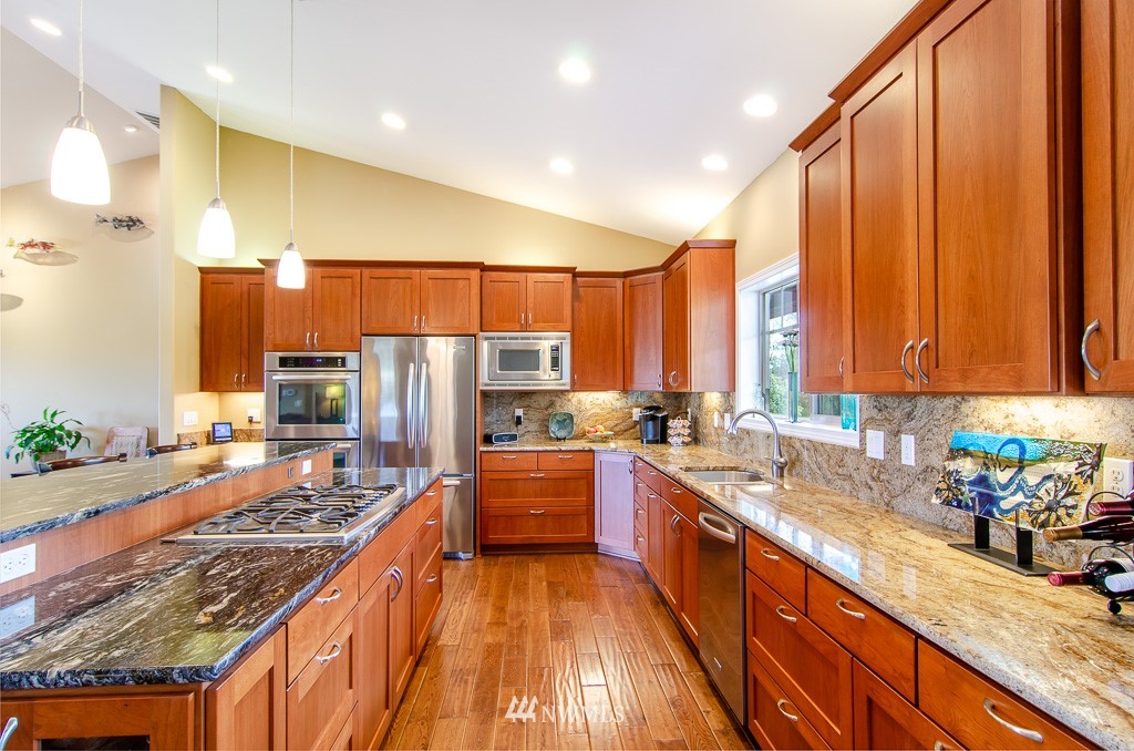 15 South Bank Road Elma, WA 98541 - Photo 10 of 32 a kitchen with stainless steel appliances a sink stove and refrigerator
