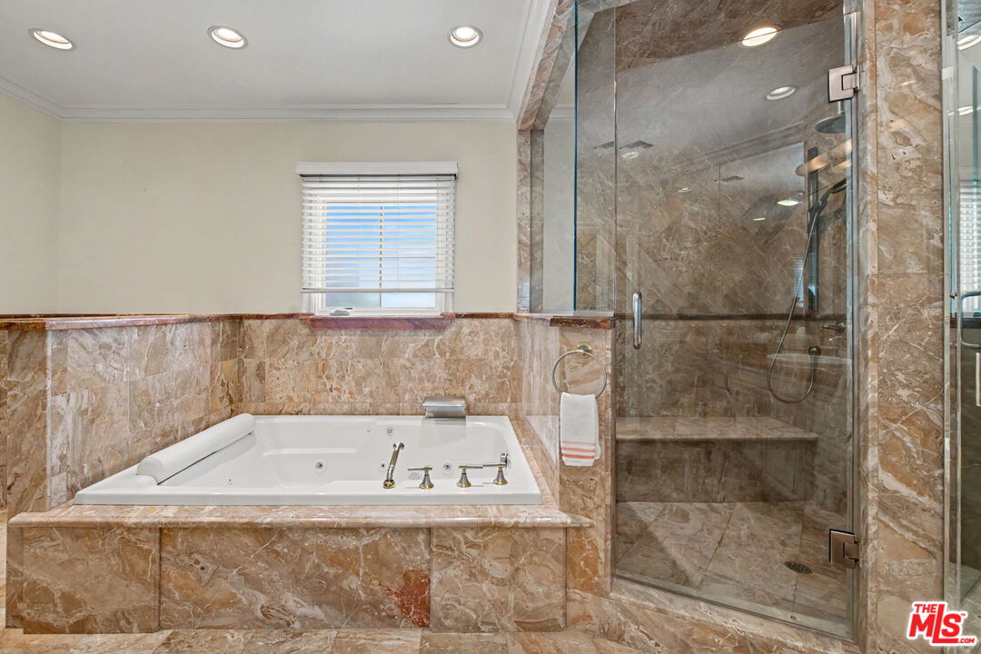 204 Foothill Road Beverly Hills, CA 90210 - Photo 23 of 38 a bathroom with a bathtub and shower