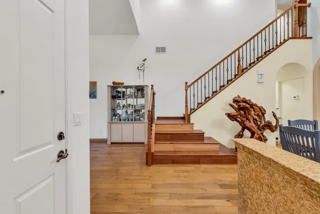 a view of entryway and hall with wooden floor