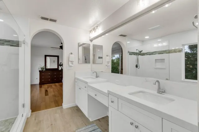 a living room with patio furniture dining table a chandelier and a potted plant