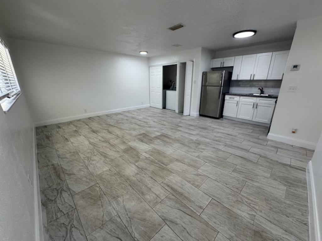 481 Banks Road, Unit 1 Margate, FL 33063 - Photo 4 of 13 a view of a kitchen with a sink and a refrigerator