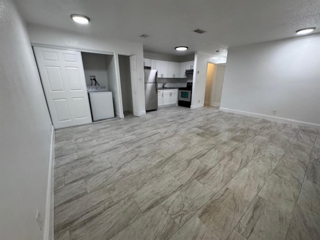 481 Banks Road, Unit 1 Margate, FL 33063 - Photo 5 of 13 a view of a kitchen with a sink and a refrigerator