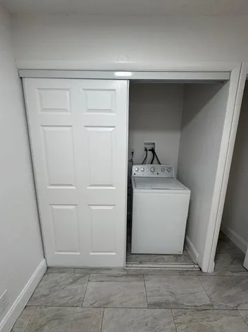 a utility room with cabinets washer and dryer