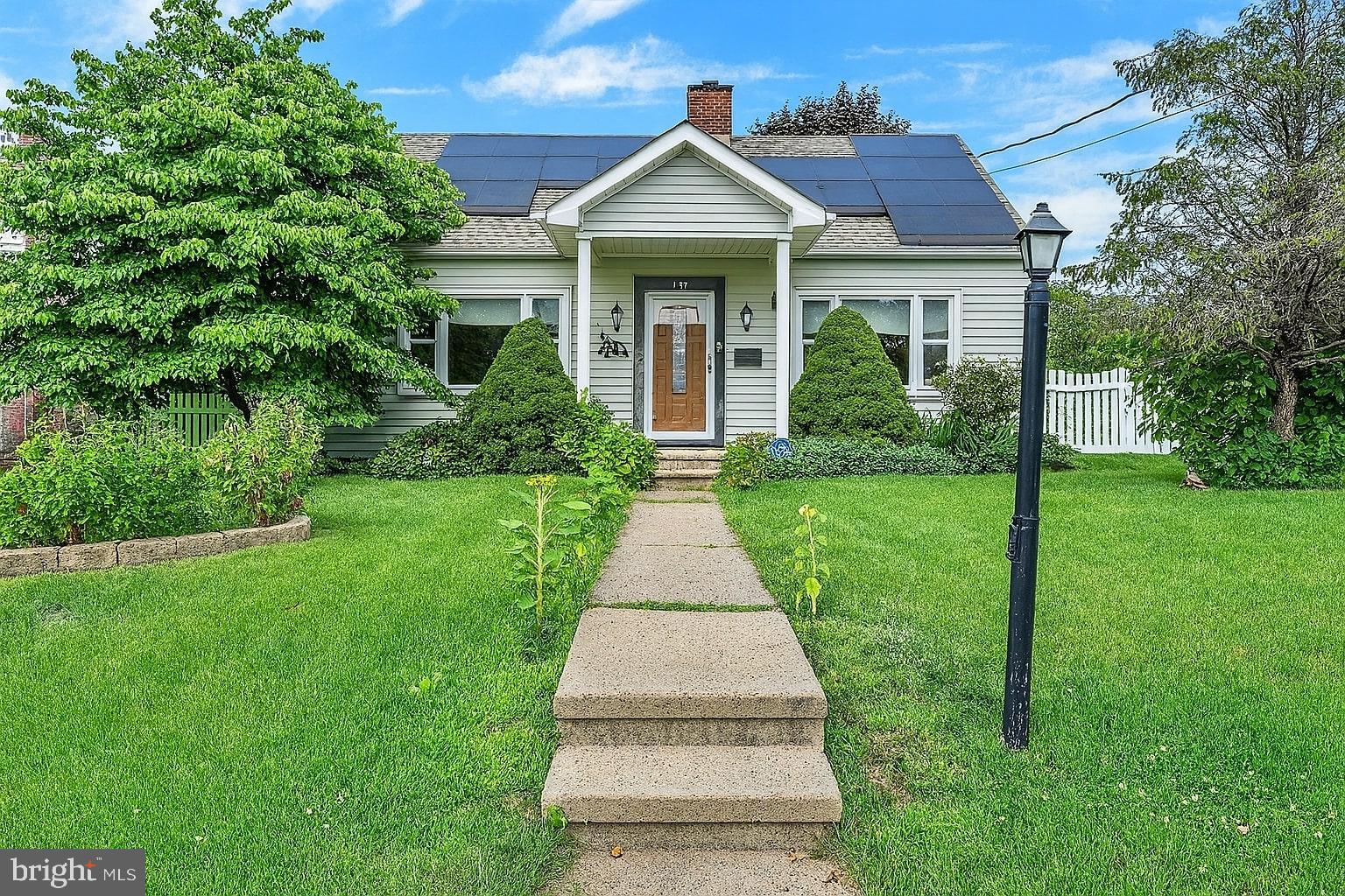 809 Van Reed Road Wyomissing, PA 19610 - Photo 1 of 25 Charming home with lush greenery and solar panels.