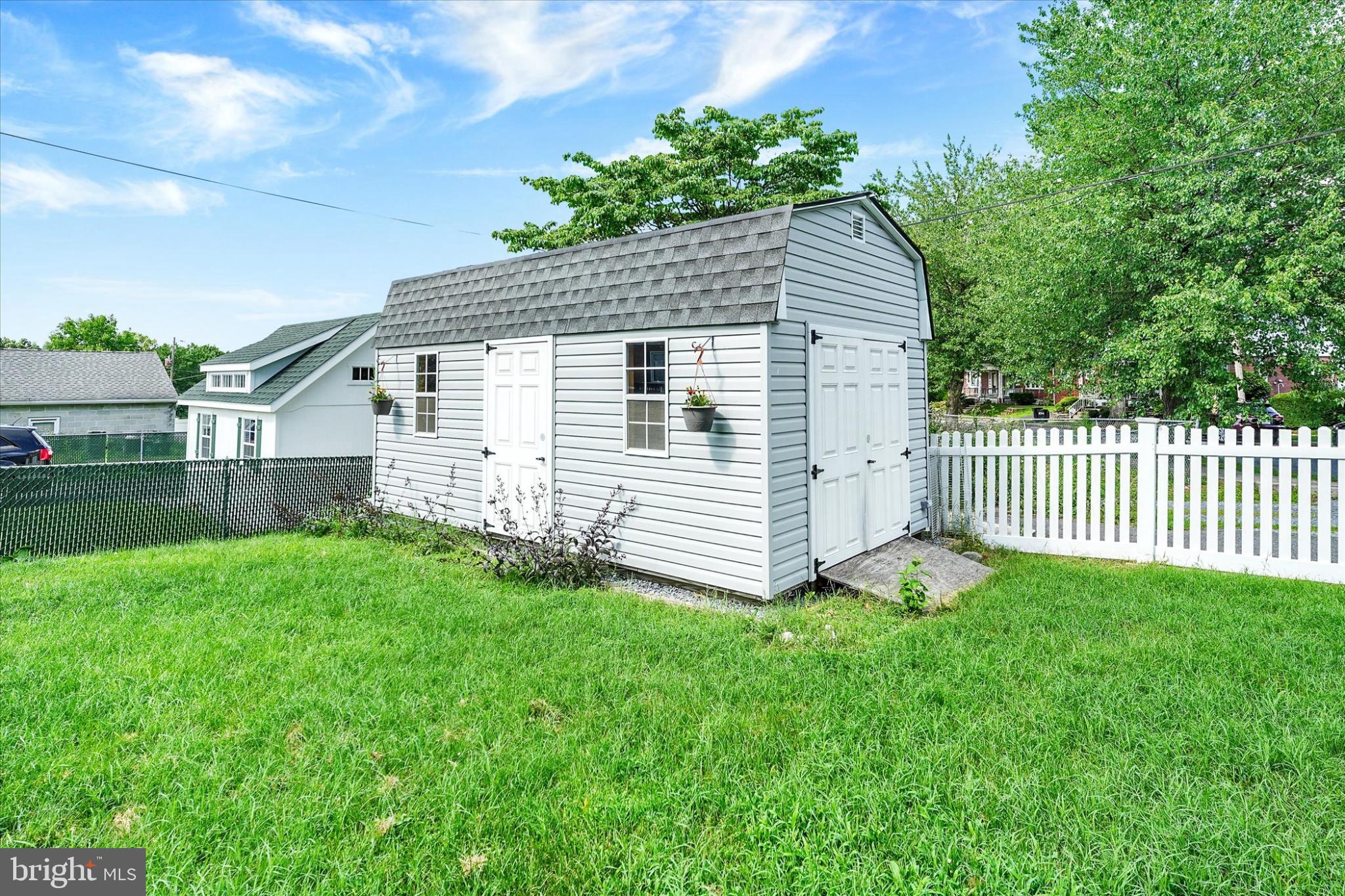 809 Van Reed Road Wyomissing, PA 19610 - Photo 23 of 25 Charming shed nestled in a lush green yard.