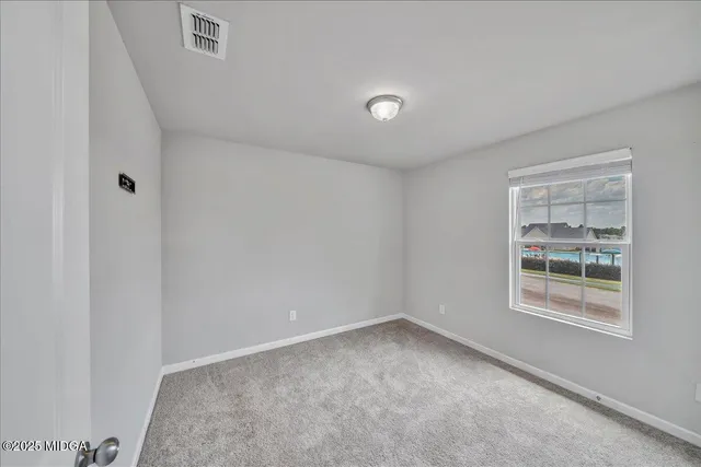 a view of an empty room and a window