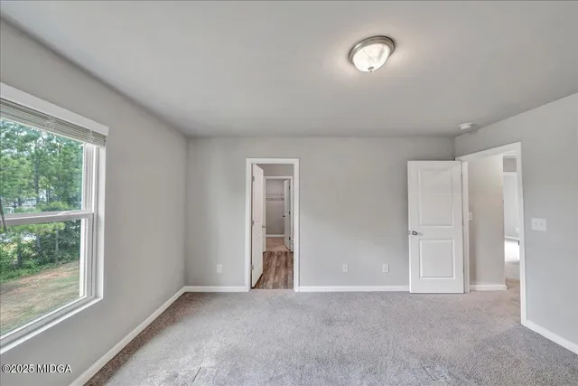 a bathroom with a sink and mirror with toilet