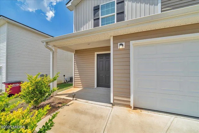 a potted plant sitting in front of a house