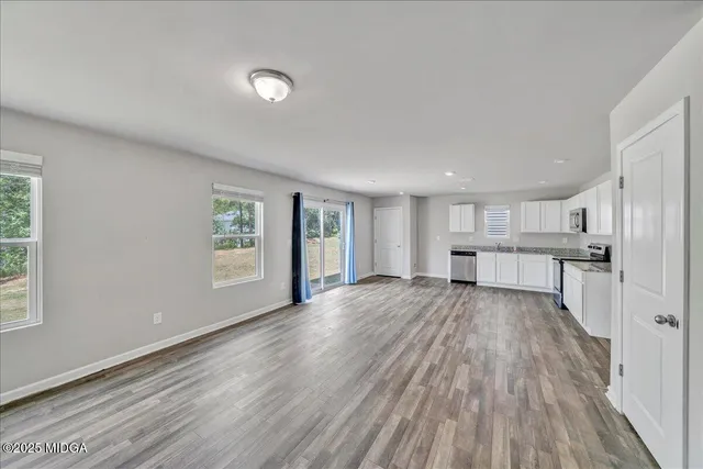 a view of kitchen with wooden floor and electronic appliances
