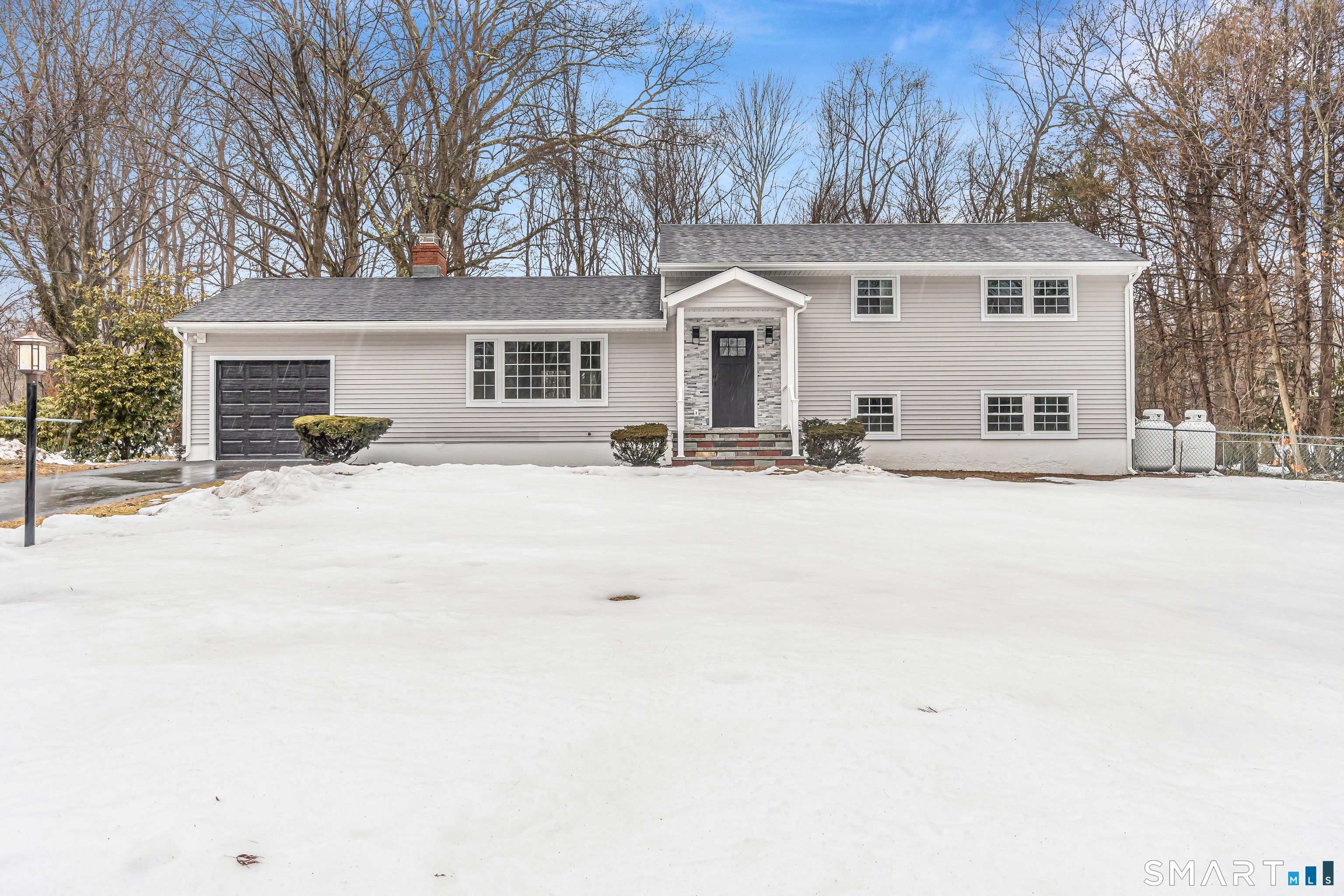 317 Narrow Lane Orange, CT 06477 - Photo 1 of 1 a front view of a house with a yard covered in snow