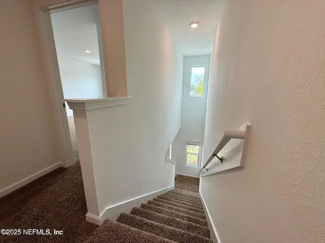 a living room with a couch and a floor to ceiling window