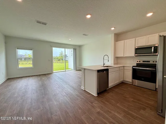 a kitchen with granite countertop a stove and a sink