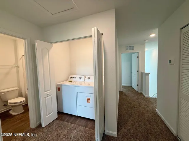 a view of bathroom with a toilet sink and mirror