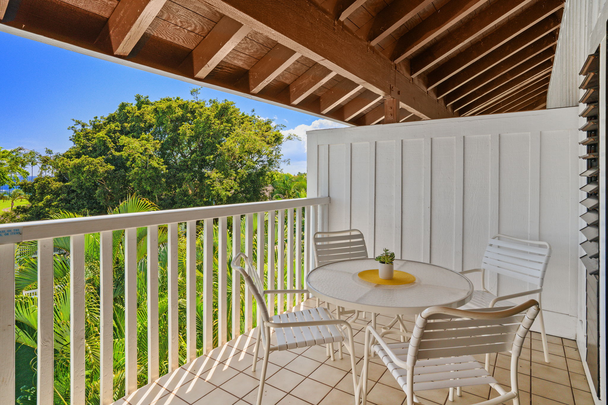 2253 Poipu Road, Unit 99 Koloa, HI 96756 - Photo 16 of 30 a balcony with table and chairs