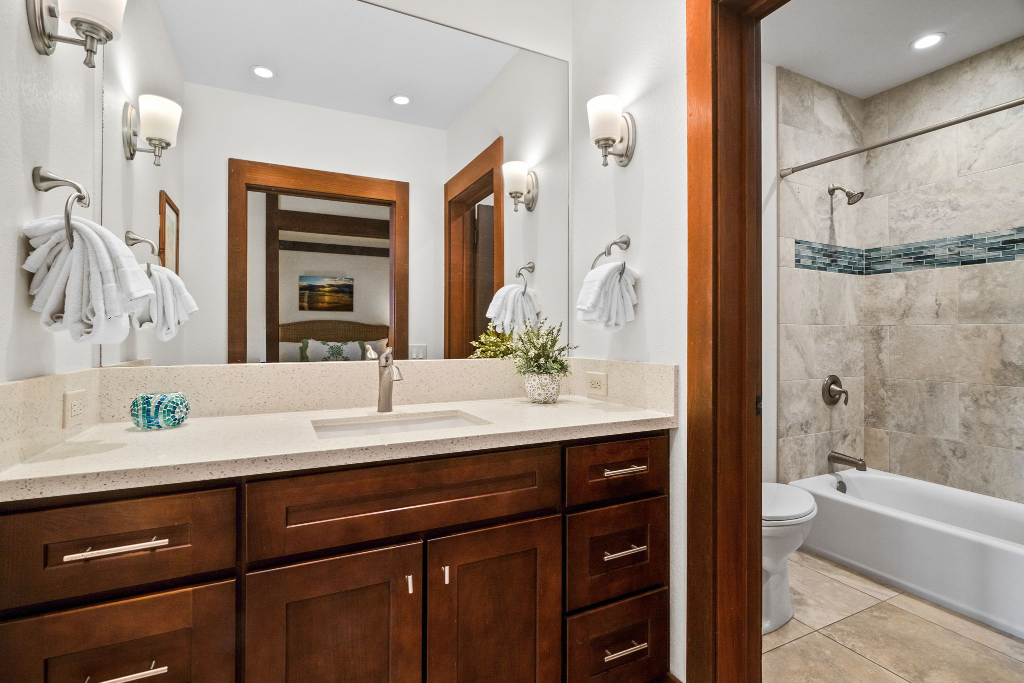 2253 Poipu Road, Unit 99 Koloa, HI 96756 - Photo 18 of 30 a bathroom with a sink double vanity granite tub shower and a mirror