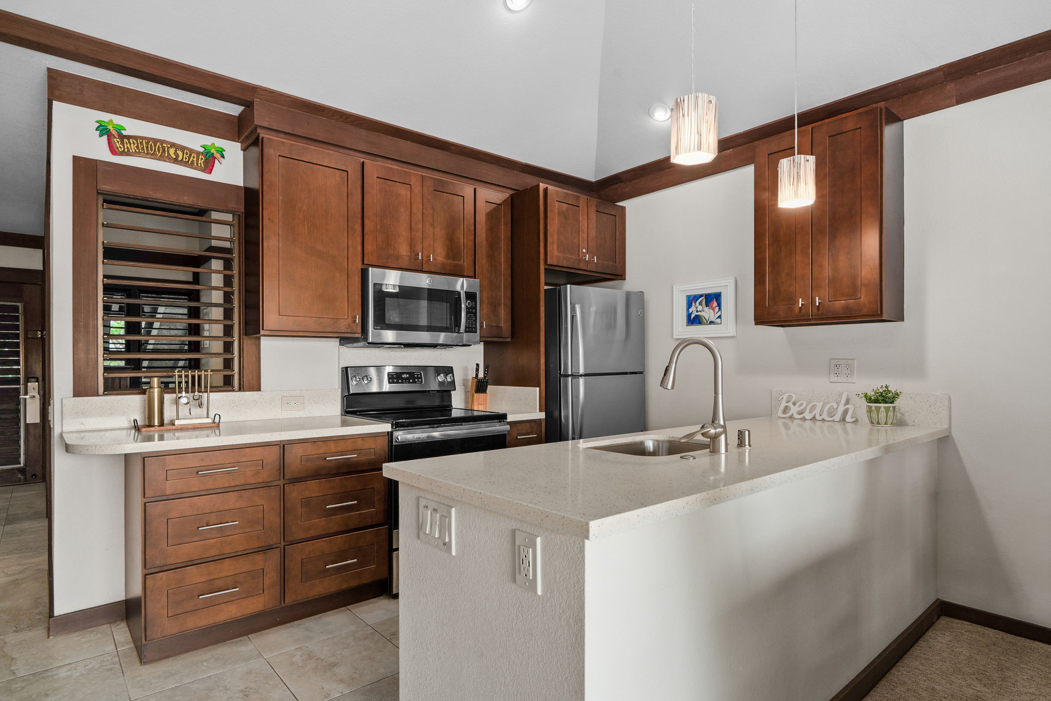 2253 Poipu Road, Unit 99 Koloa, HI 96756 - Photo 9 of 30 a kitchen with a sink stove and microwave