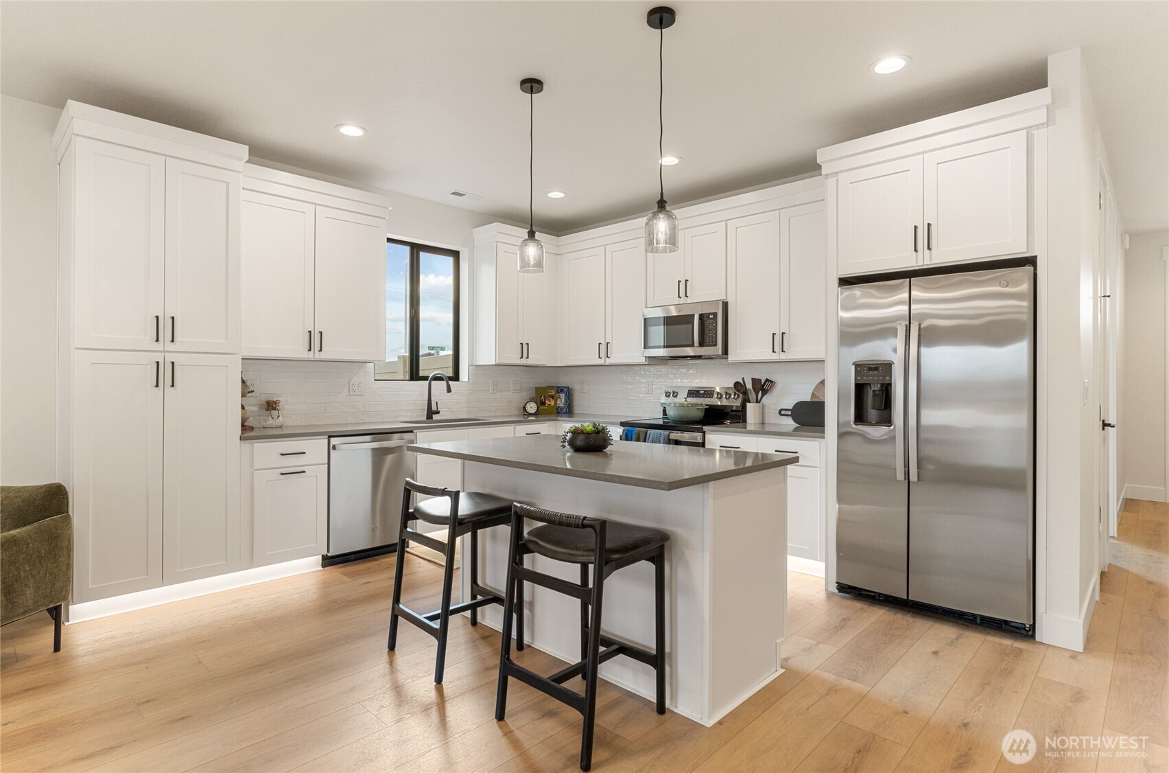 581 South Oasis Loop East Wenatchee, WA 98802 - Photo 12 of 33 a kitchen with stainless steel appliances granite countertop a refrigerator a sink dishwasher a stove and white cabinets with wooden floor