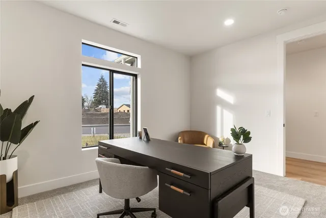 a view of a workspace with furniture