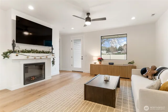 a living room with furniture a flat screen tv and a fireplace