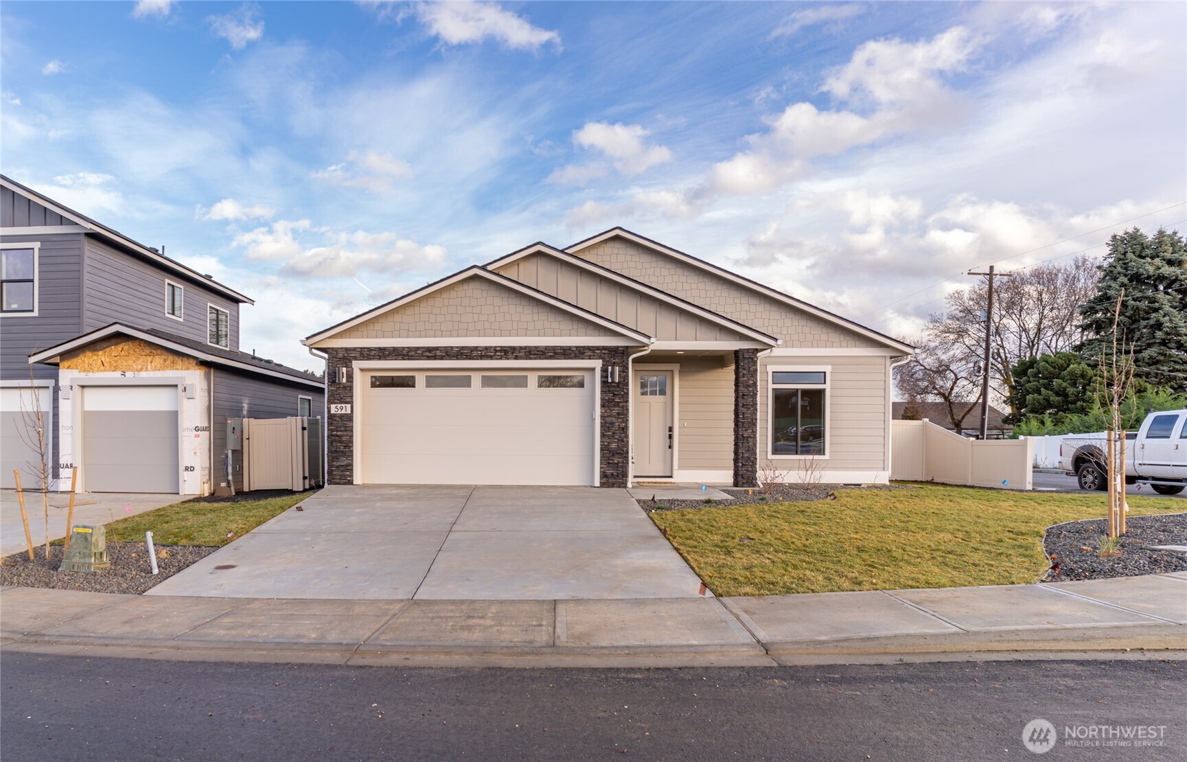 581 South Oasis Loop East Wenatchee, WA 98802 - Photo 26 of 33 a front view of a house with a yard and garage