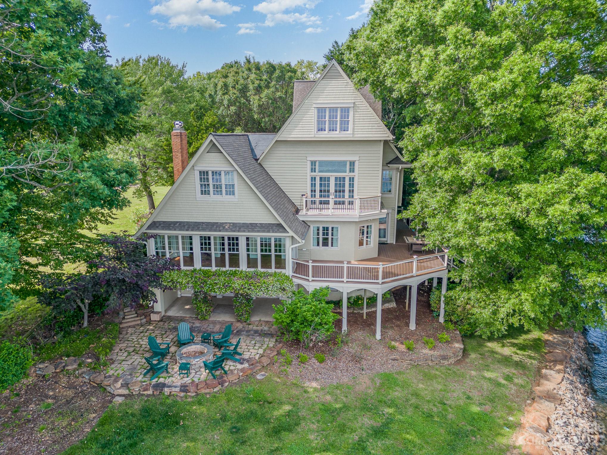 a front view of a house with a yard and trees