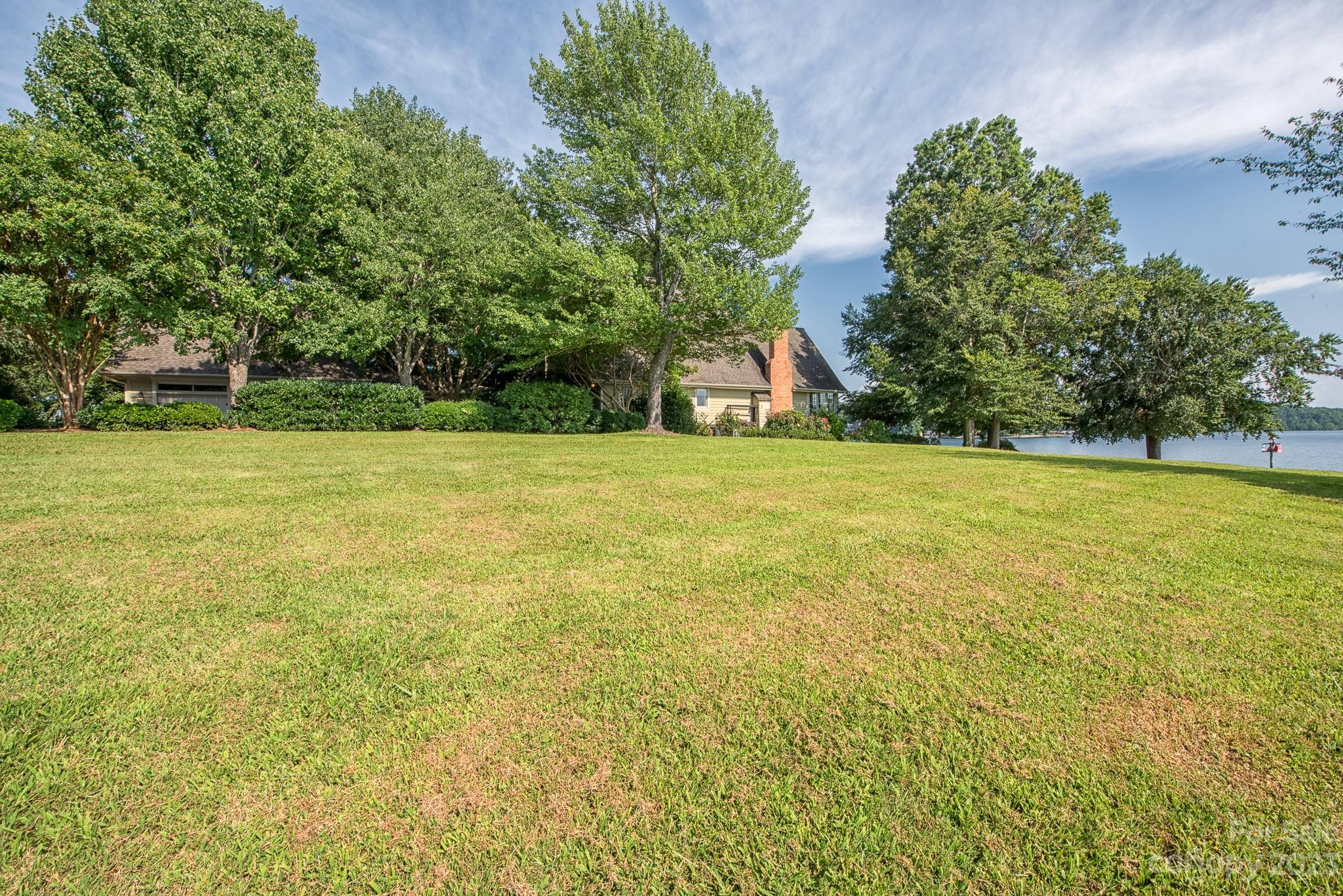 135 Winston Way Troutman, NC 28166 - Photo 13 of 48 a view of a field with some trees in front of it
