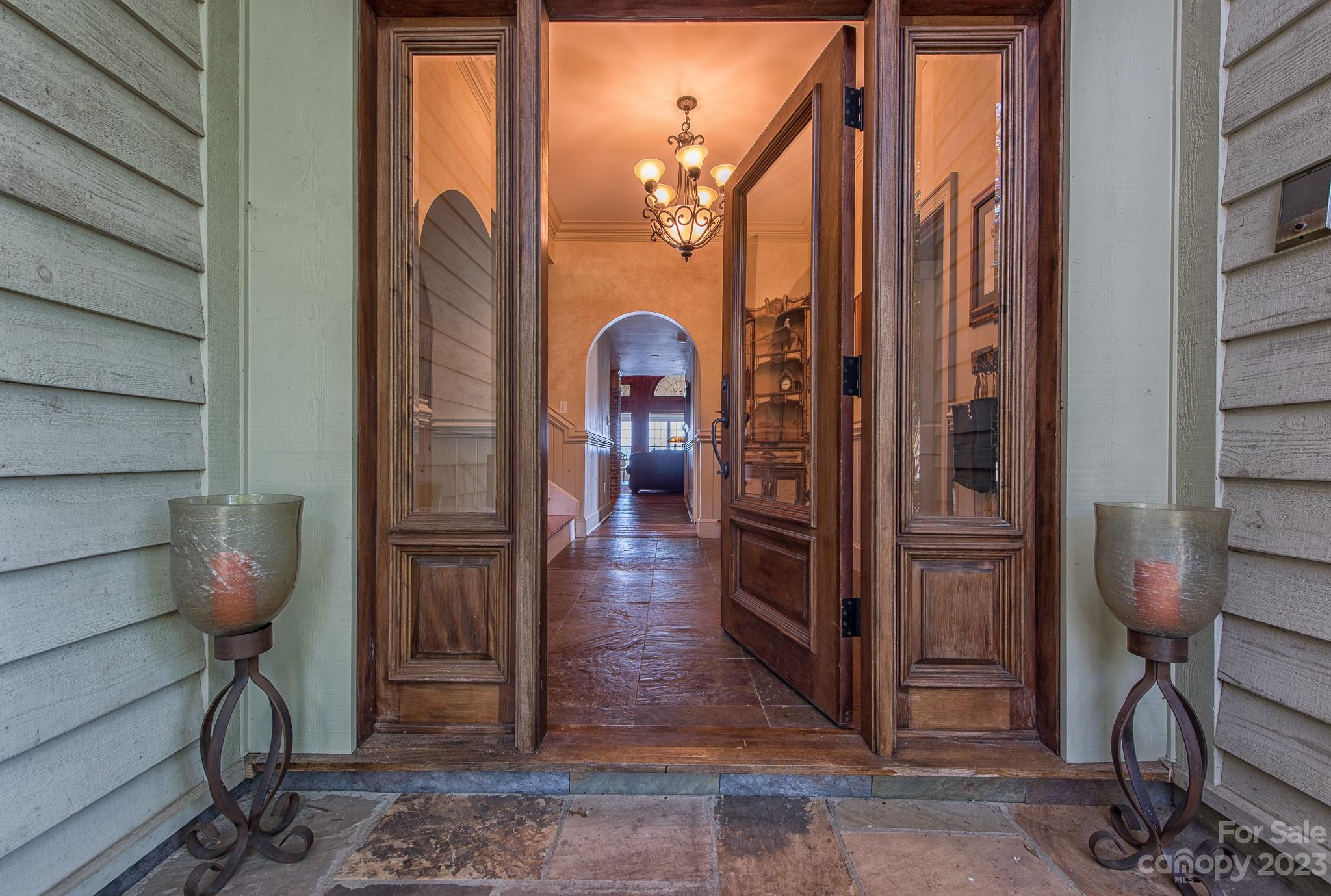 135 Winston Way Troutman, NC 28166 - Photo 14 of 48 a view of a hallway with wooden floor and a glass door