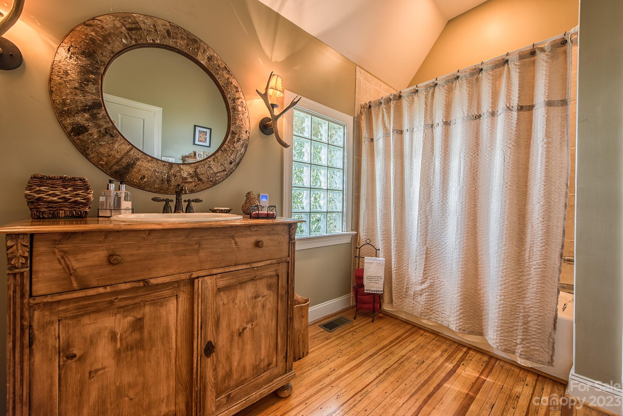 135 Winston Way Troutman, NC 28166 - Photo 16 of 48 a bathroom with a sink a mirror and a shower curtain