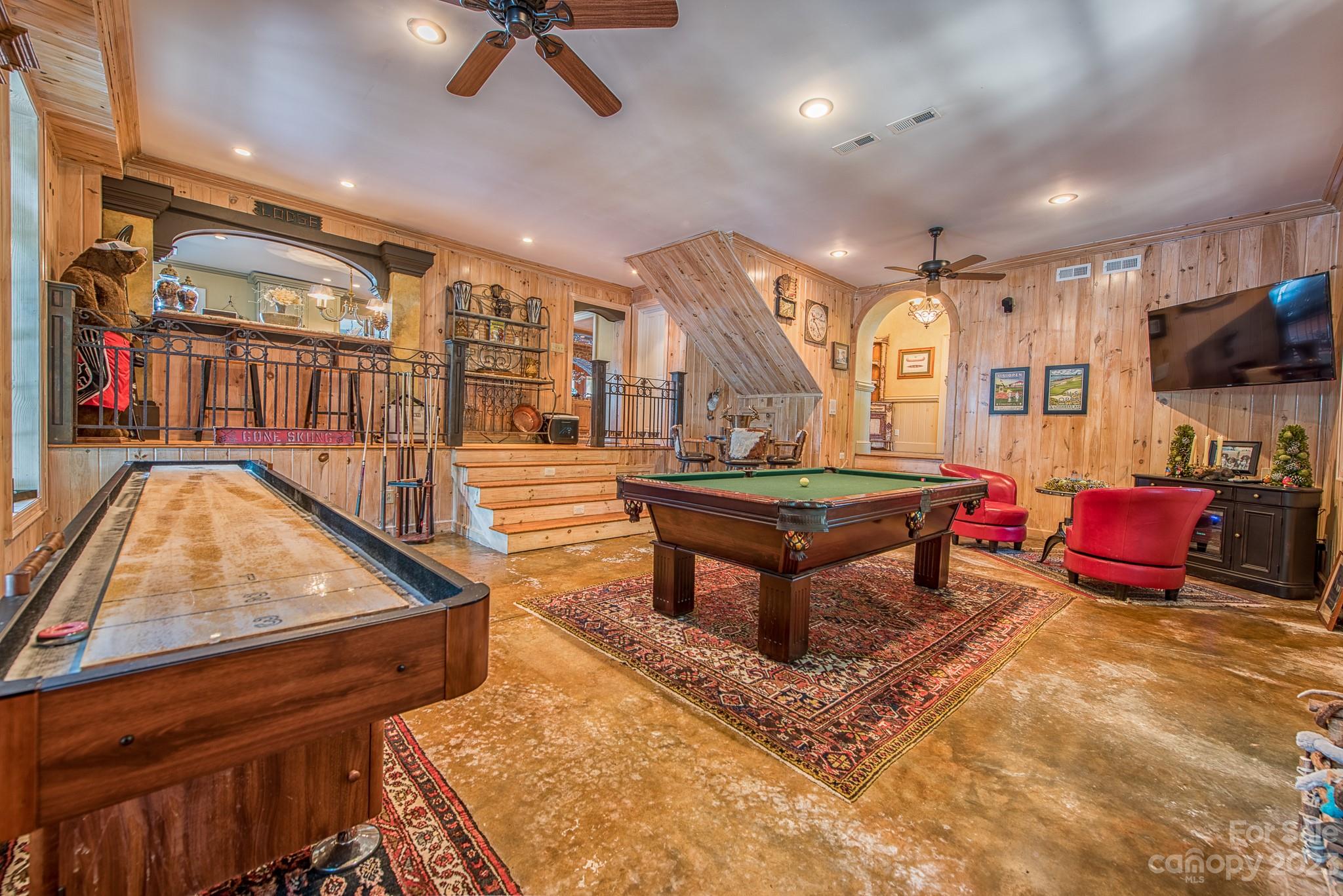 135 Winston Way Troutman, NC 28166 - Photo 18 of 48 a living room with furniture a pool table and a flat screen tv