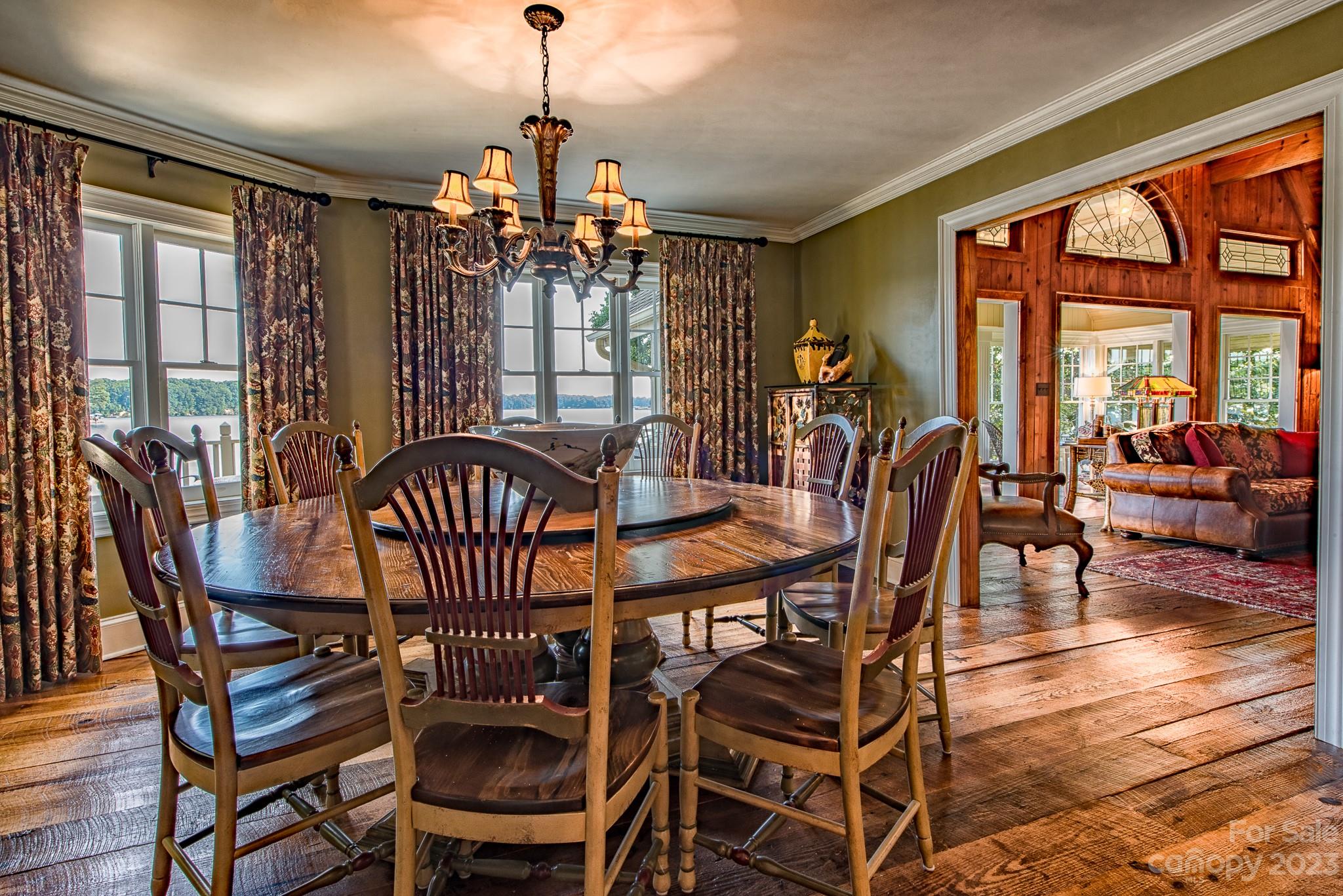135 Winston Way Troutman, NC 28166 - Photo 21 of 48 a view of a dining room with furniture wooden floor and a chandelier