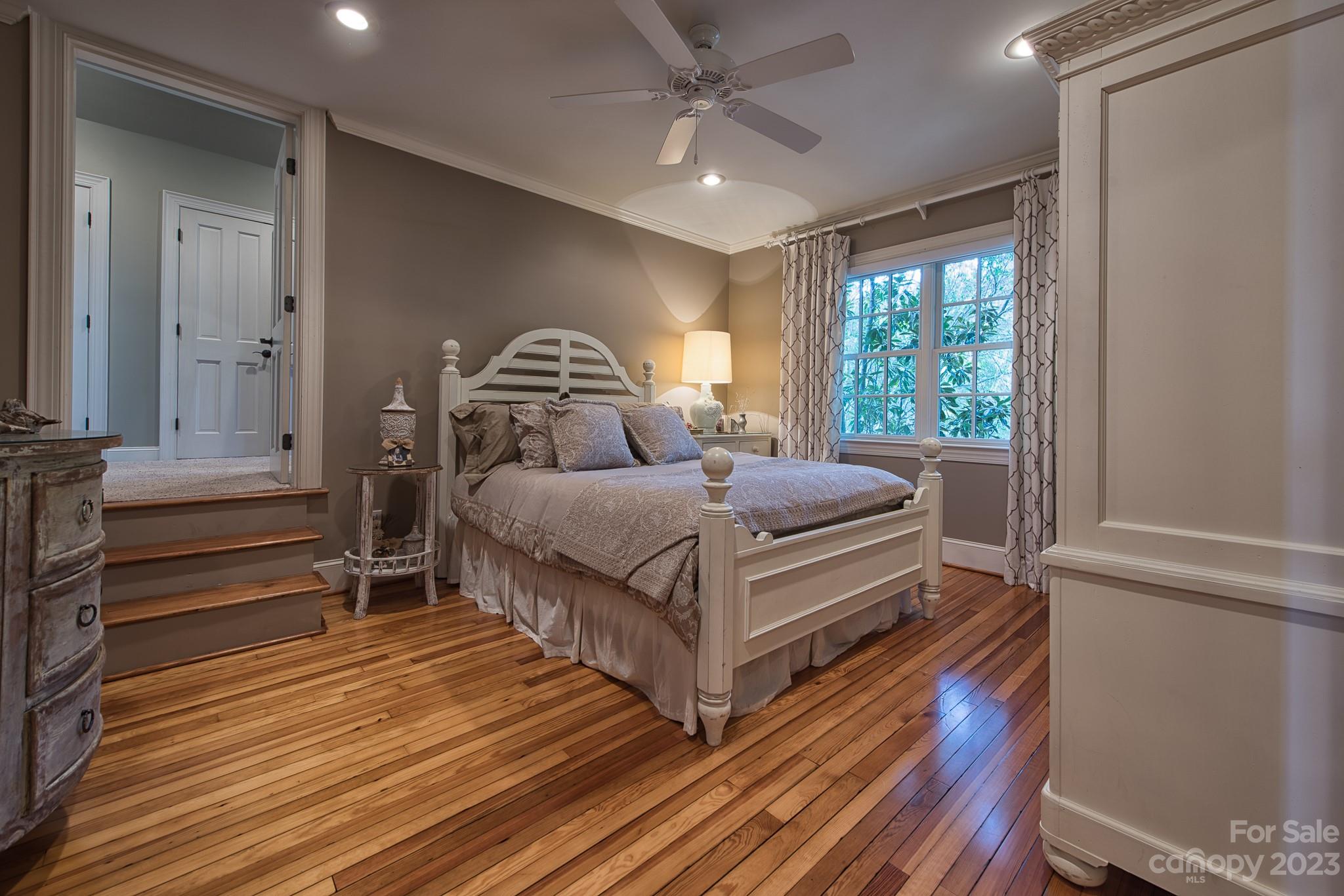 135 Winston Way Troutman, NC 28166 - Photo 38 of 48 a bedroom with a bed and wooden floor