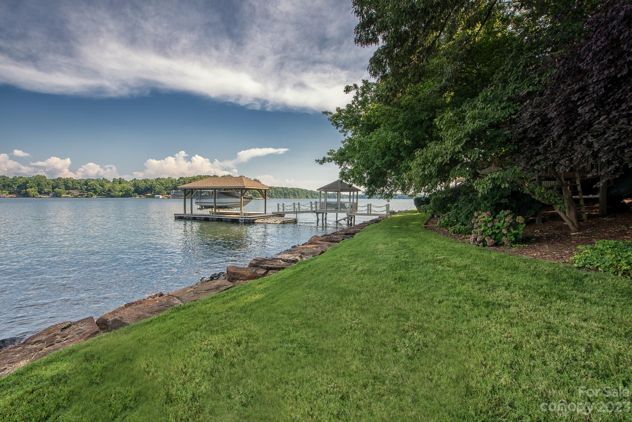 135 Winston Way Troutman, NC 28166 - Photo 6 of 48 a view of a lake with houses in the back
