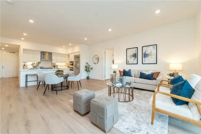 a living room with furniture and view of kitchen