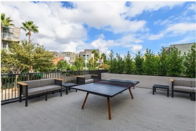 a view of a patio with couches and a table and chairs with potted plants