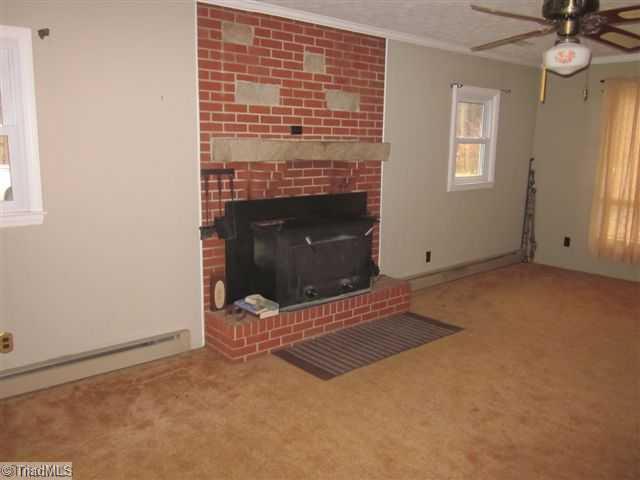 222 Wheeler Road Reidsville, NC 27320 - Photo 5 of 8 Den/Family/Great Room. FAMILY ROOM WITH WOODSTOVE seller installed EBB heat when room was built added heat pump later EBB used if needed as back up