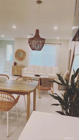 a living room with a table and chairs