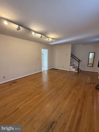 an empty room with wooden floor