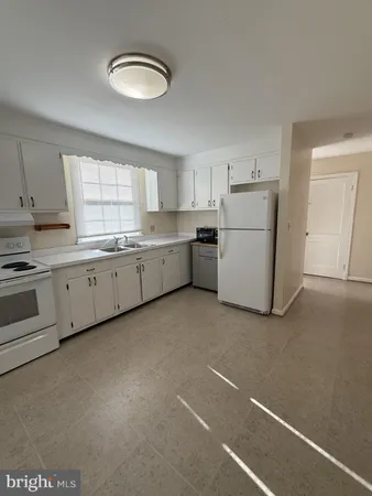 a kitchen with a cabinets and white appliances