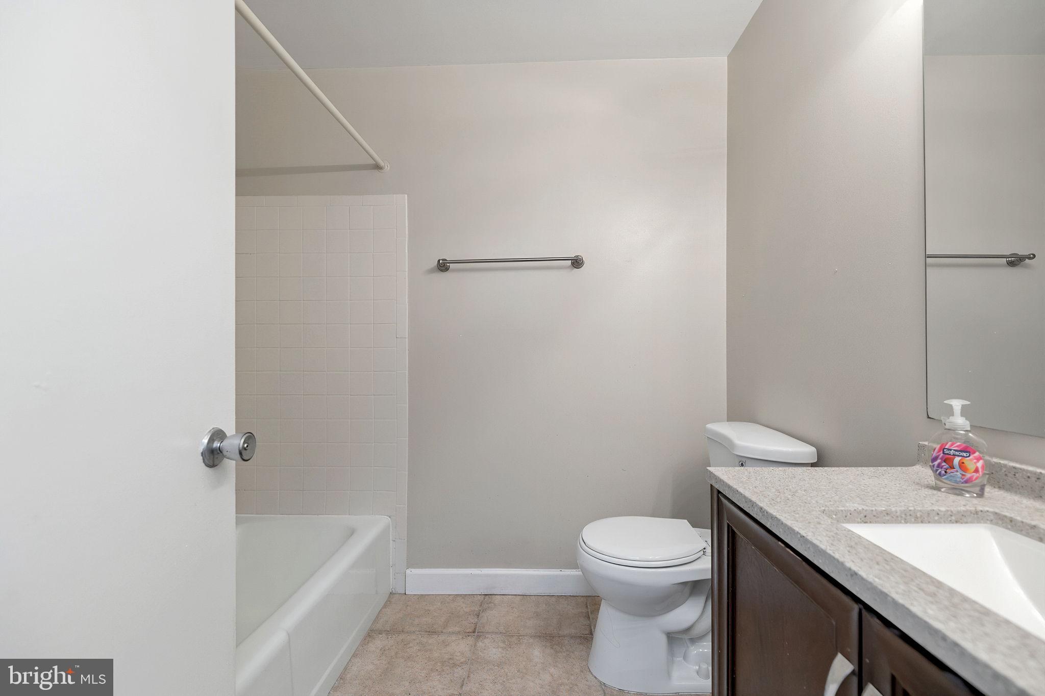 1443 Northgate Square, Unit 22B Reston, VA 20190 - Photo 14 of 42 a bathroom with a granite countertop sink a toilet and shower