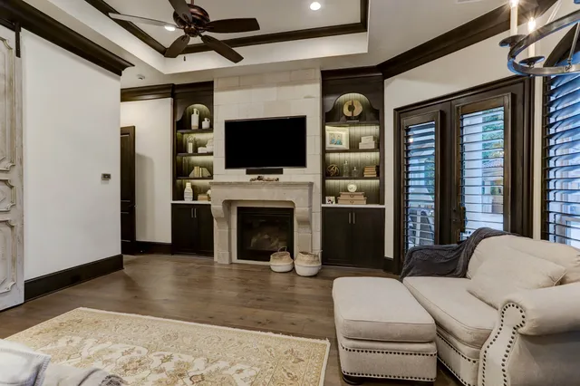 a living room with furniture a flat screen tv and a fireplace