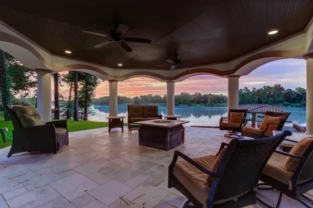 a living room with patio furniture and a floor to ceiling window