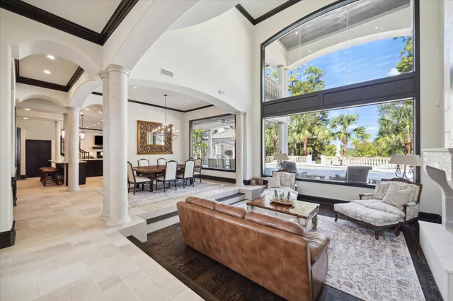 a living room with furniture large window and a table