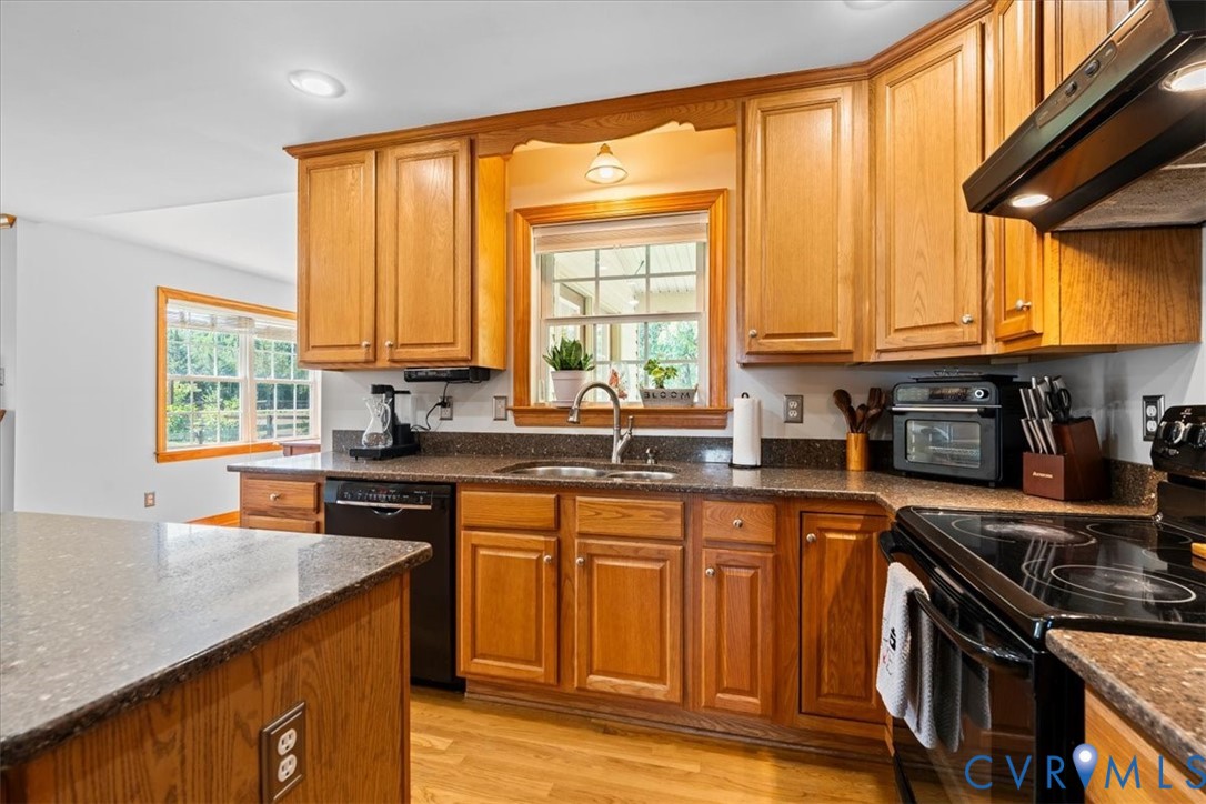 3137 Trenholm Road Powhatan, VA 23139 - Photo 19 of 72 a kitchen with stainless steel appliances granite countertop a stove a sink and a microwave
