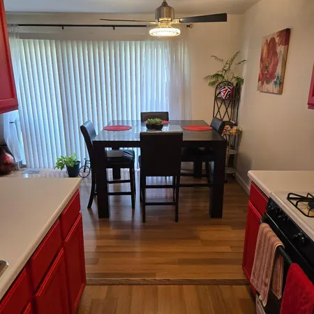 a view of a dining room with furniture and wooden floor