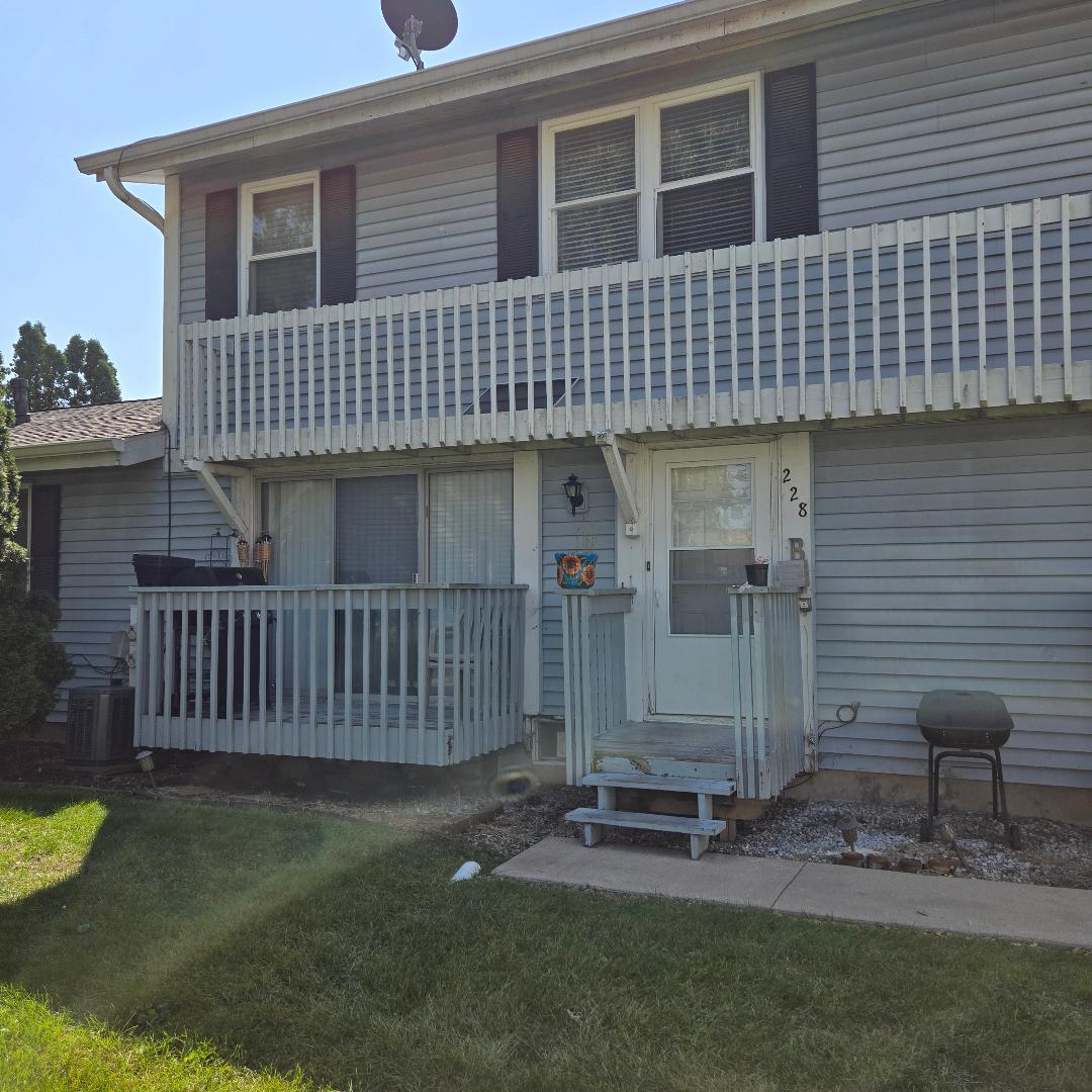 228 Elkhorn Court, Unit B Bolingbrook, IL 60440 - Photo 6 of 15 a front view of a house with a garden