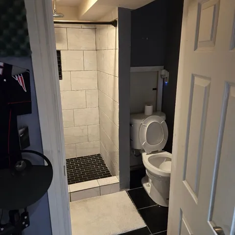 a bathroom with a granite countertop toilet and a sink