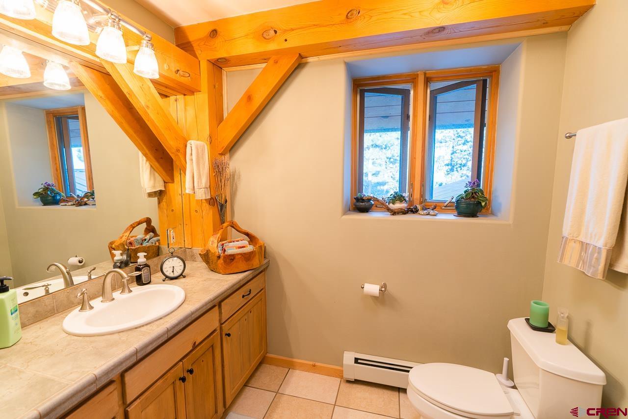 200 Longview Lane Bayfield, CO 81122 - Photo 18 of 33 a bathroom with a granite countertop toilet sink and mirror